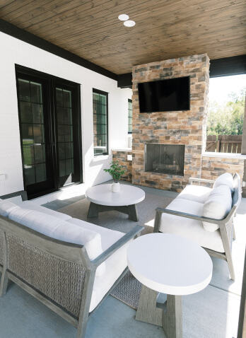 outdoor living space with fireplace and television
